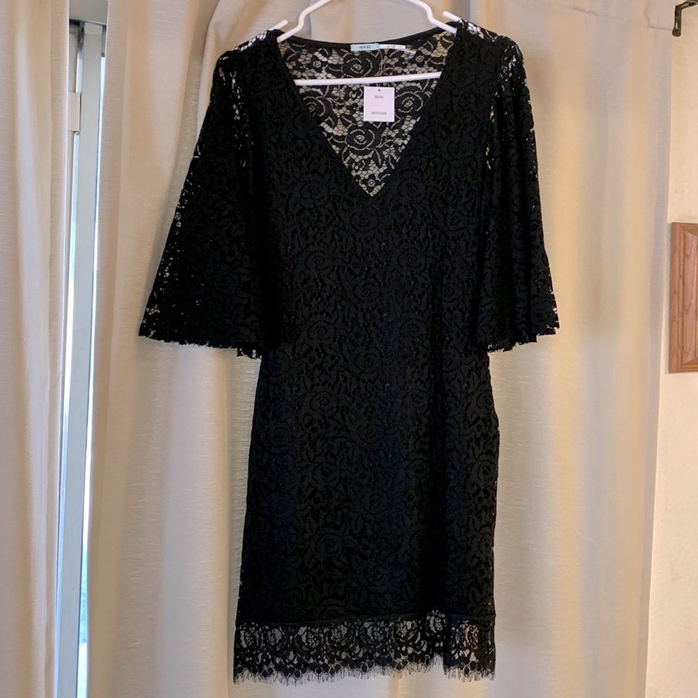 Cute black mini dress with large flowy sleeves. Never worn.